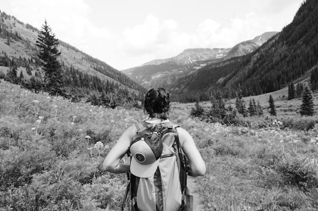woman with backpack on in a valley